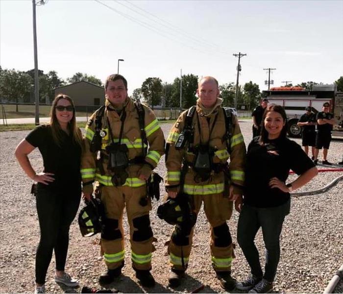 two females with two male Firefighters