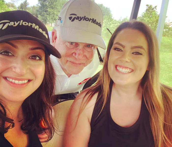 two women and a man in golf cart at BOMA Golf Outing